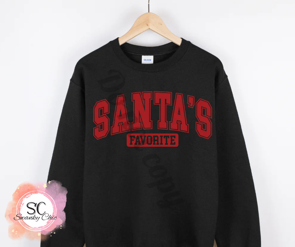 Brenda McCoy Hoodlebrink — Santa’s Favorite (varsity red): Medium, black, long sleeve tee